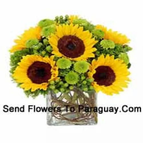 Sunflowers With Suitable Seasonal Fillers Arranged Beautifully In A Glass Vase